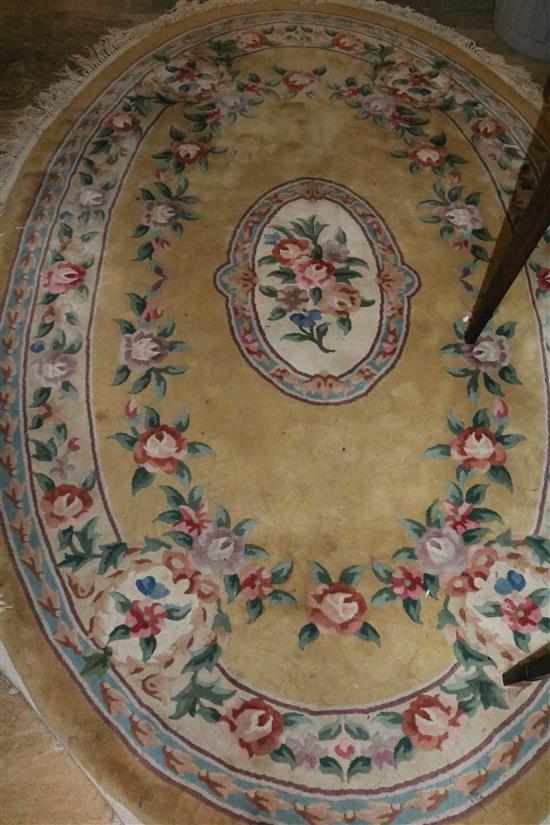Chinese gold ground flower embossed oval rug